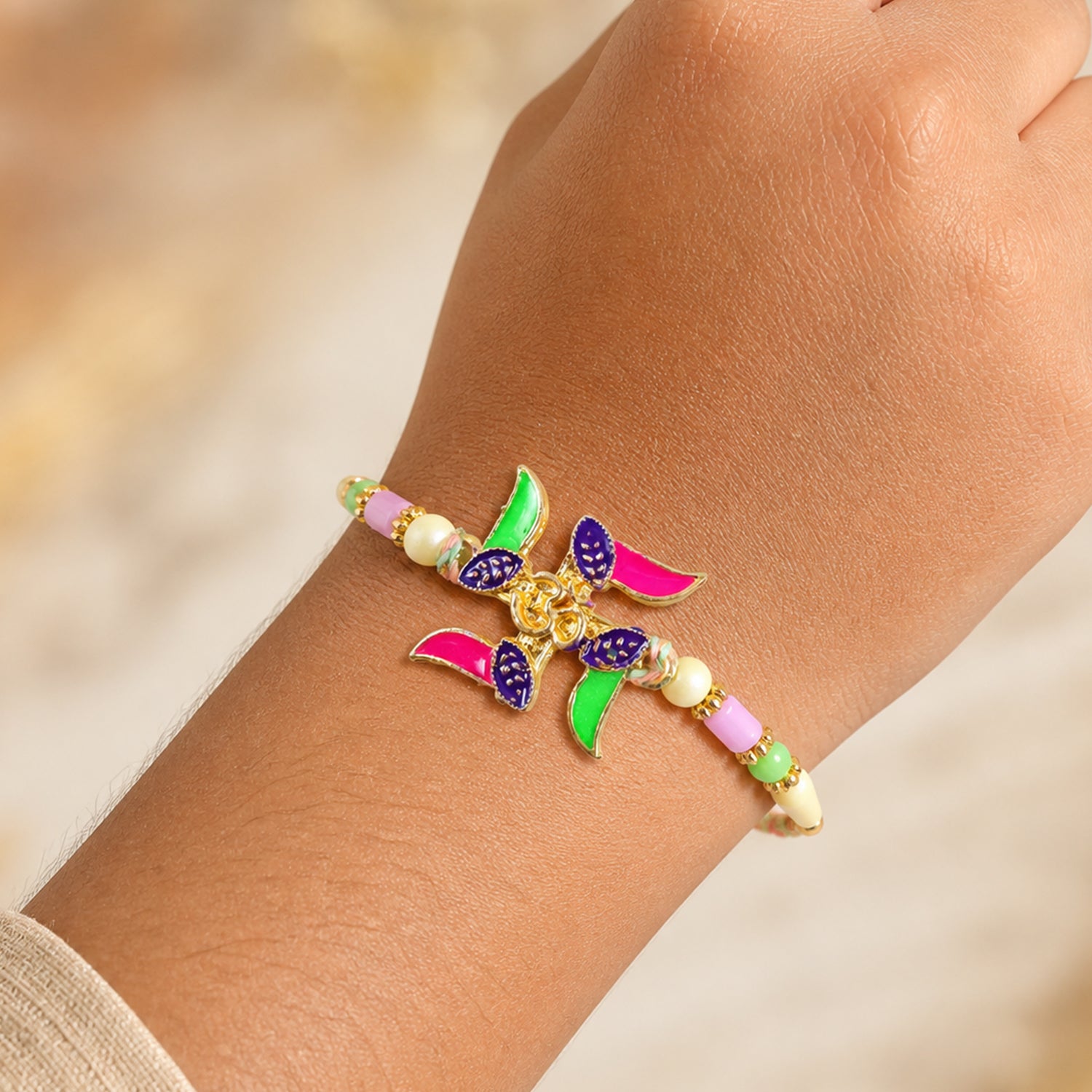 Ornate Rakhi with Butterfly Flower Charm and pearl accents in bead line for Gift Use