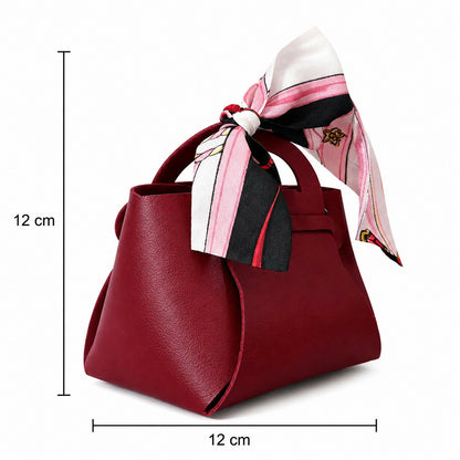 Maroon mini handbag displayed open with essentials