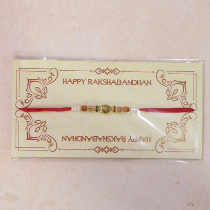 Red Thread Rakhi with Floral Gold Oval Charm and Multicolour Beads