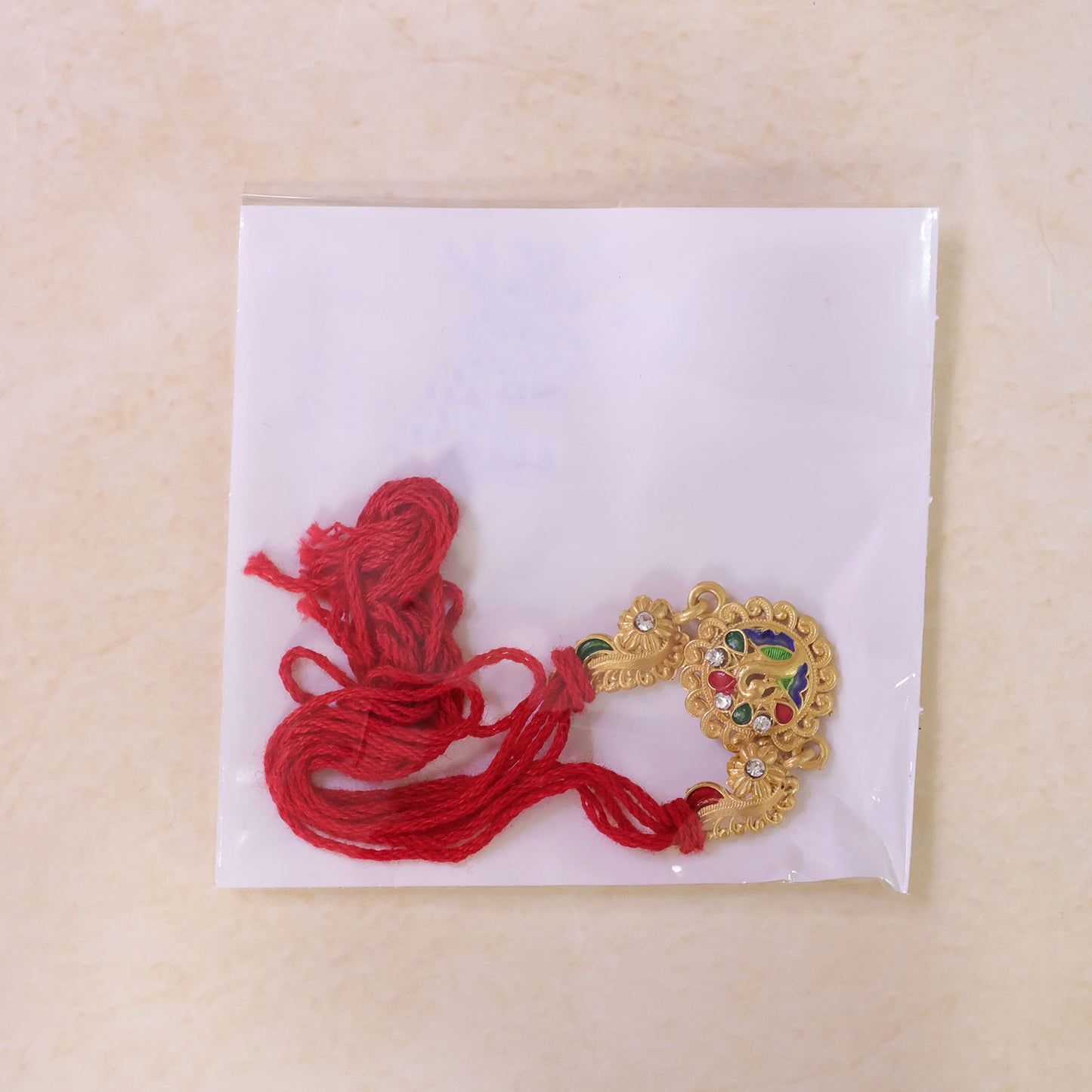 Graceful Rakhi with Floral Medallion, pink green stones and bead line for Gift Use