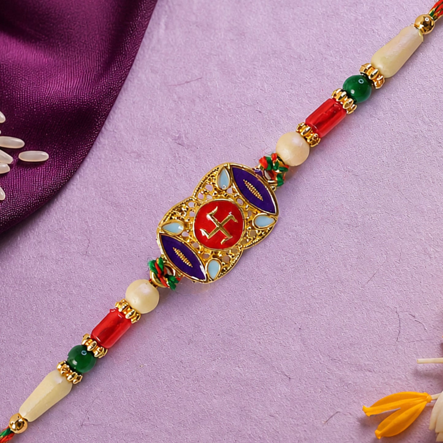Festive Rakhi featuring Swastik Medallion and gold trims in display look for Gift Use