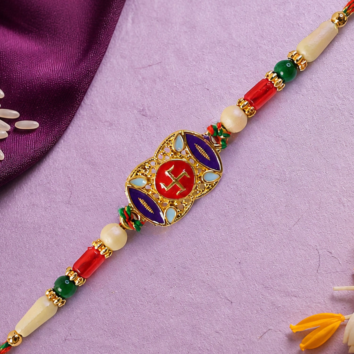 Festive Rakhi featuring Swastik Medallion and gold trims in display look for Gift Use