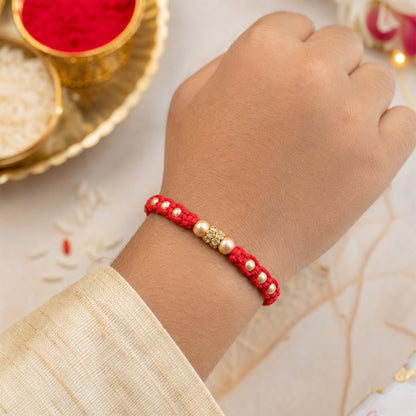 Red Thread Rakhi with Smooth Golden Beads and Sparkling Rhinestone Spacer