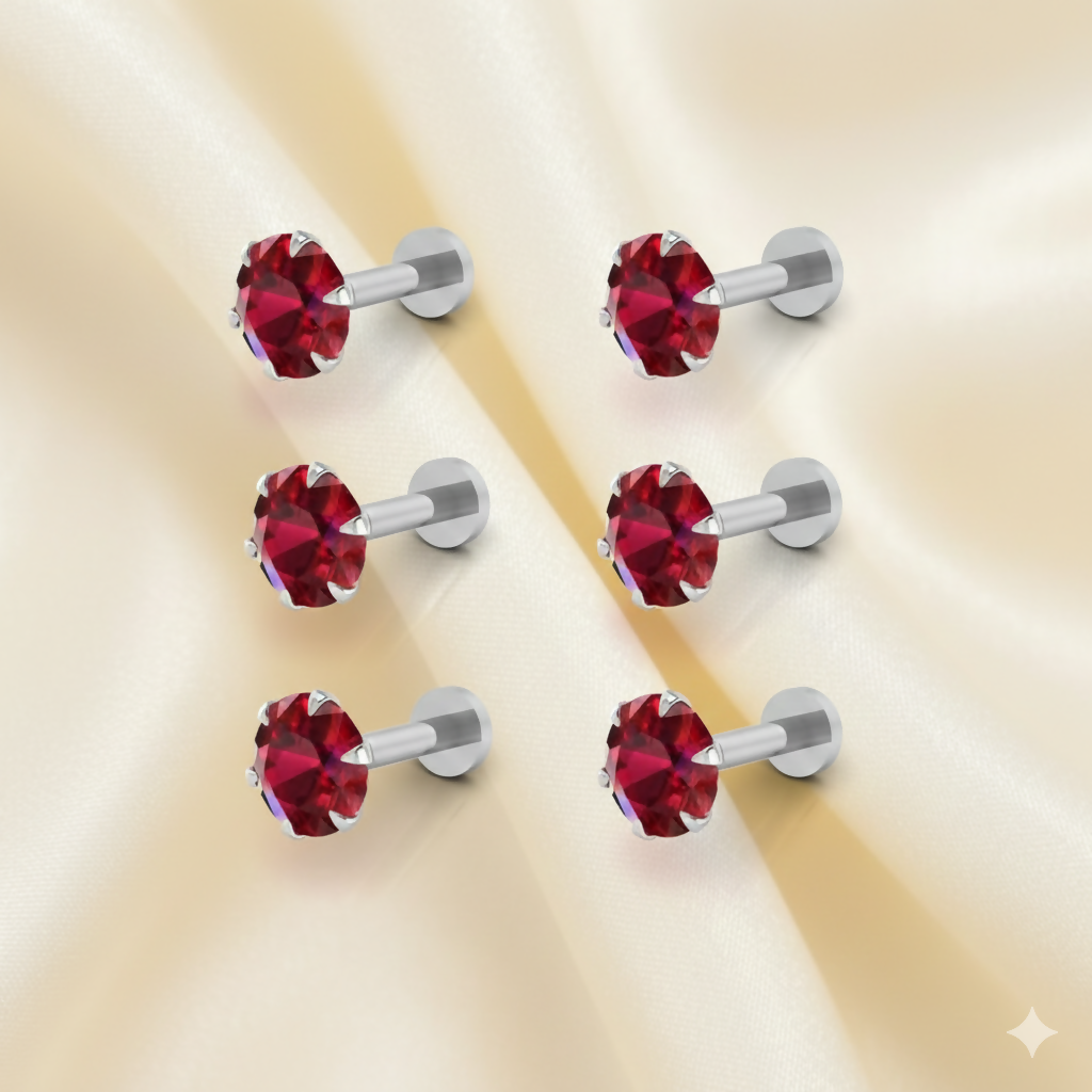 Close-up view of a red crystal nosepin stud with silver plating