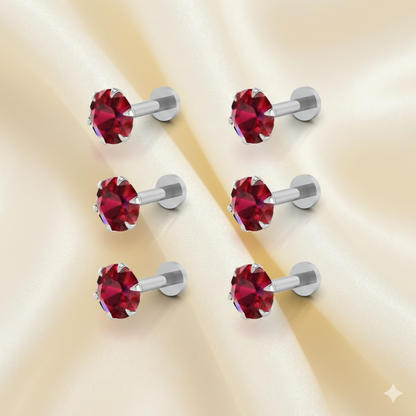 Close-up view of a red crystal nosepin stud with silver plating