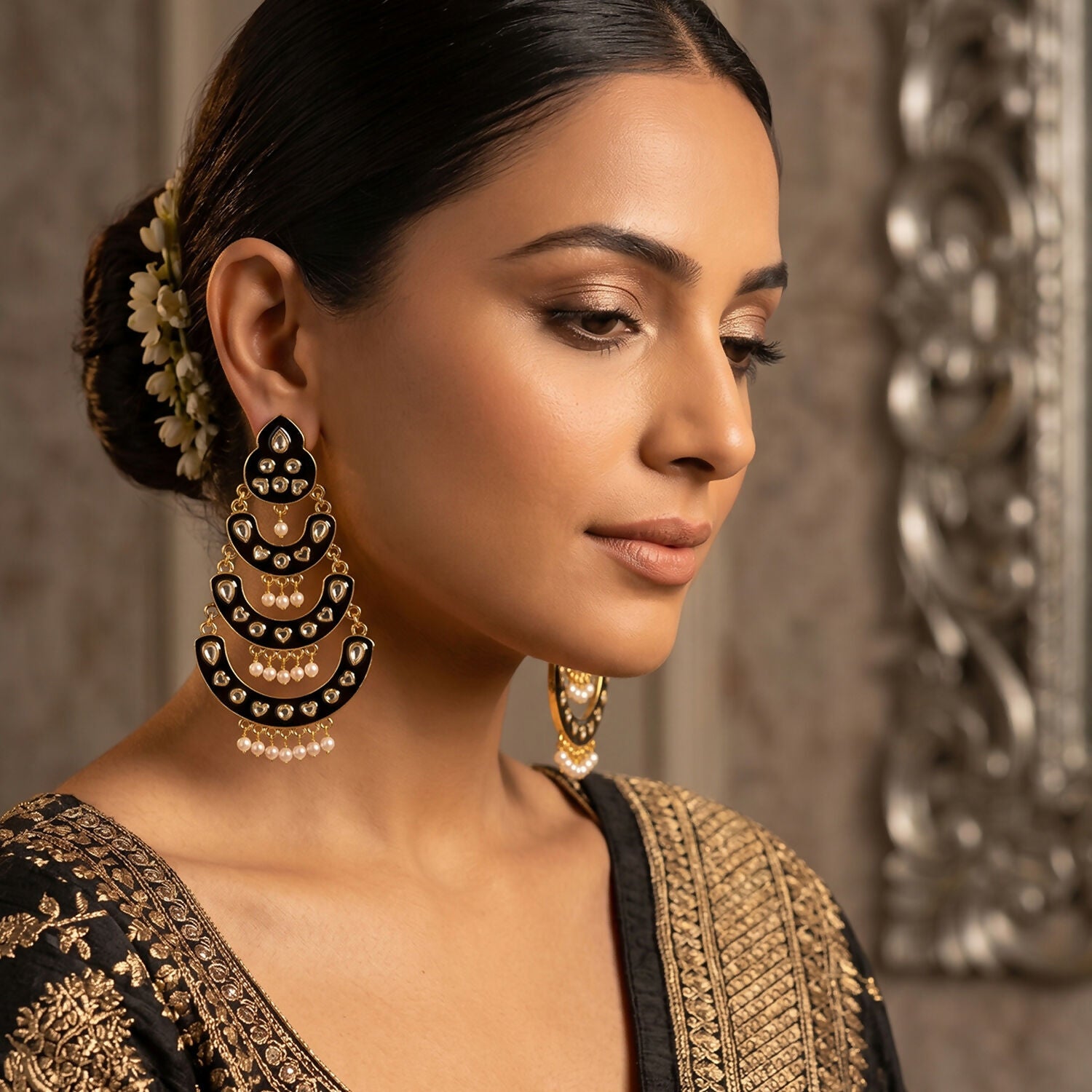 Close-up of pearl drops on maroon chandbali earrings