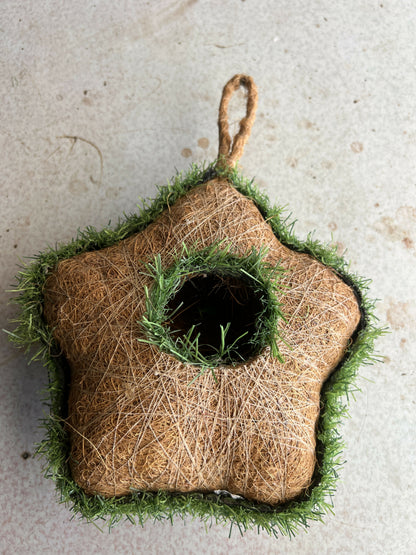 Close-up of natural coir fiber texture on star-shaped bird house