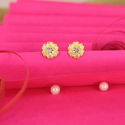 Close-up of gold plated floral stud earrings with brilliant Cubic Zirconia stones