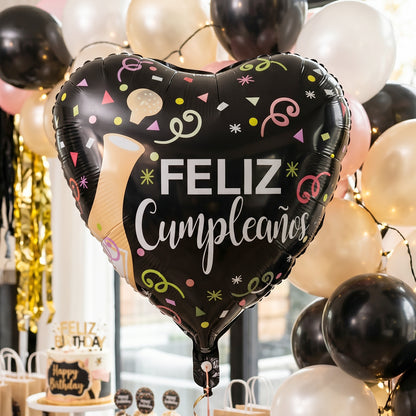 Black Heart Feliz Cumpleaños foil balloon displayed in party setting