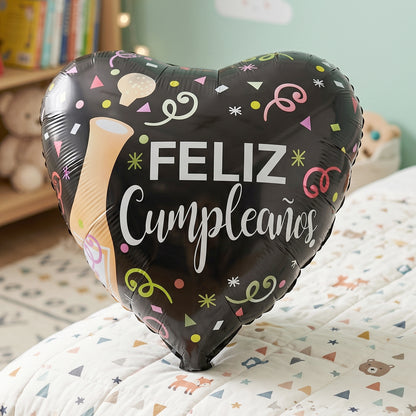 Birthday party setup featuring Black Heart Feliz Cumpleaños foil balloon