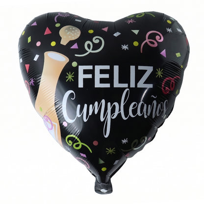 Black Heart Feliz Cumpleaños foil balloon on wall backdrop