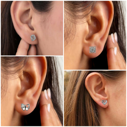 Close-up of silver bow-shaped zircon stud earrings sparkling clearly