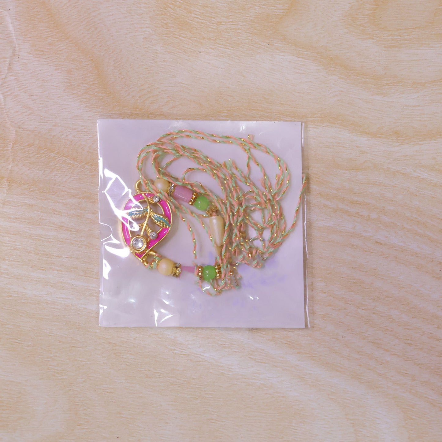 Leaf Shaped Pink and Green Enamel Pendant Rakhi with Pastel Beads