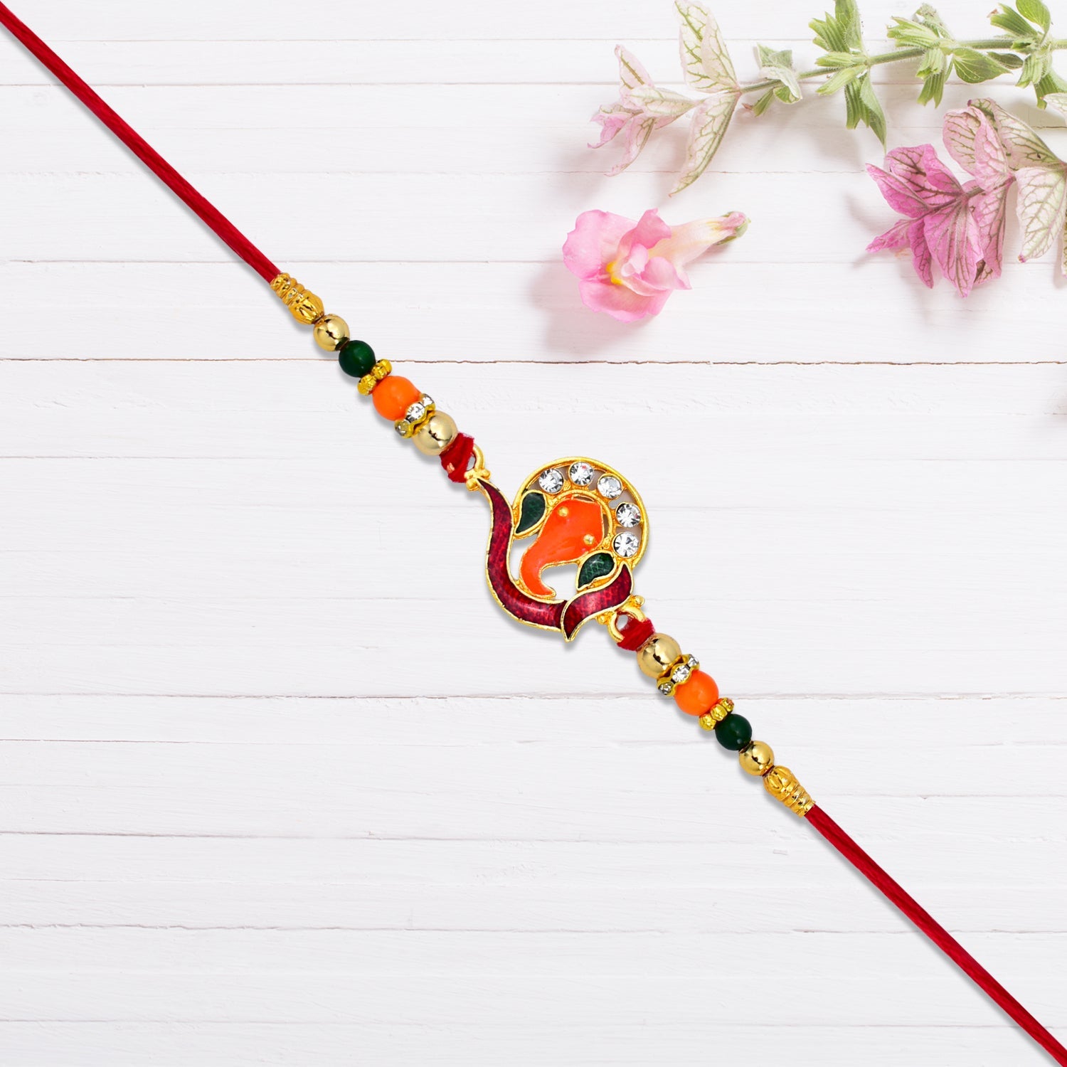 Side angle of Golden Ganesha Rakhi highlighting craftsmanship