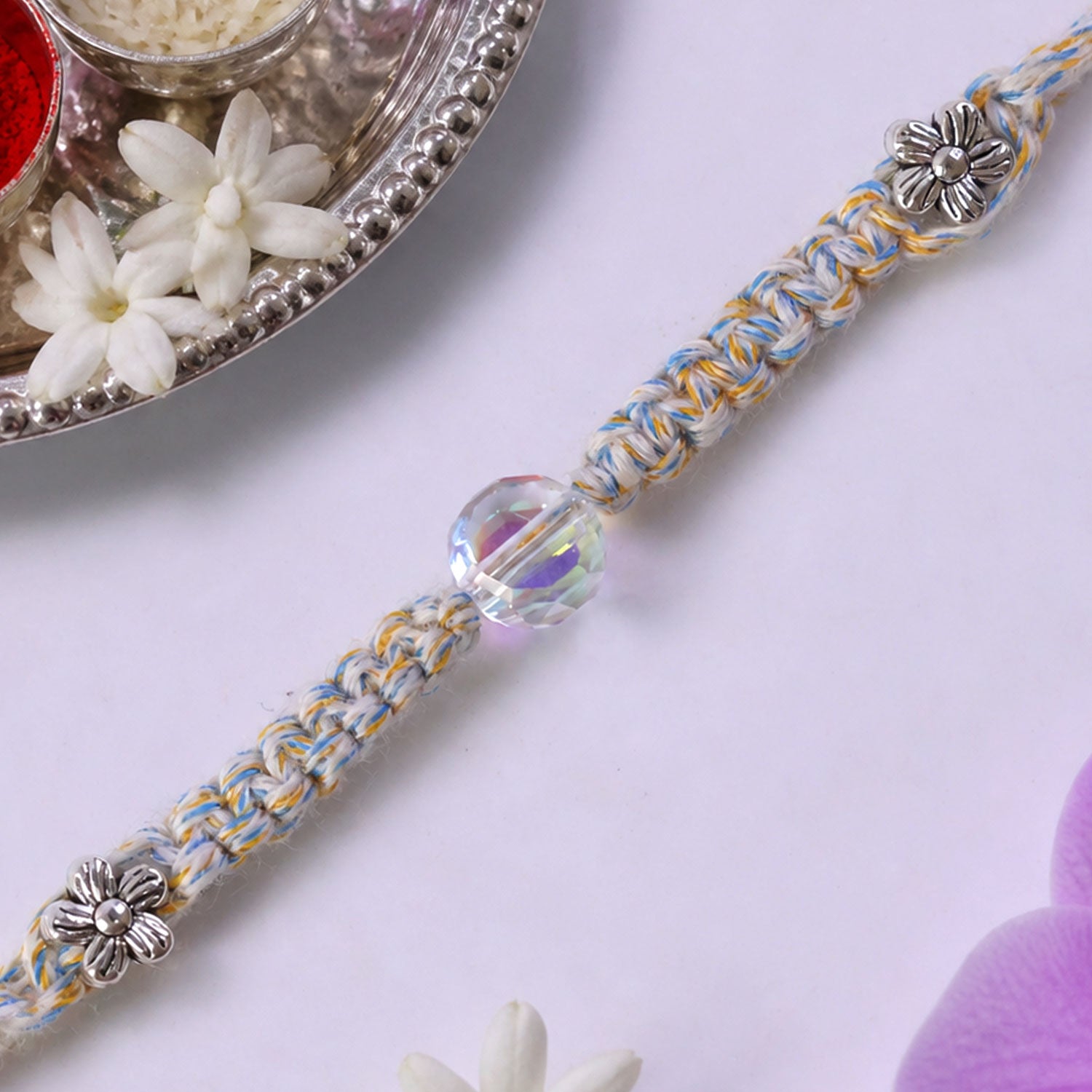Pastel Braided Rakhi with Blue-White Thread and Crystal Bead Charm for Raksha Bandhan