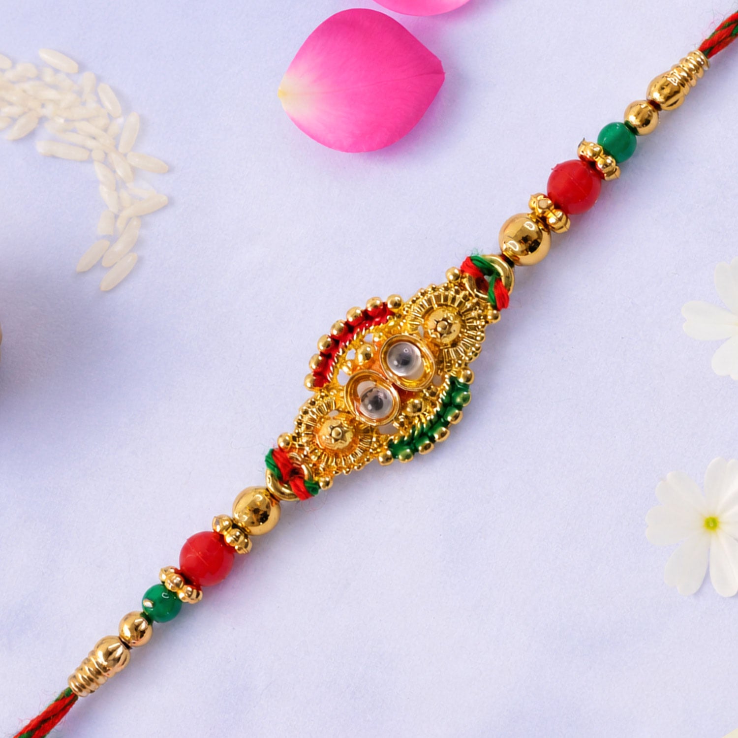 Kundan Cluster Oval Pendant Rakhi with Red and Cream Beads