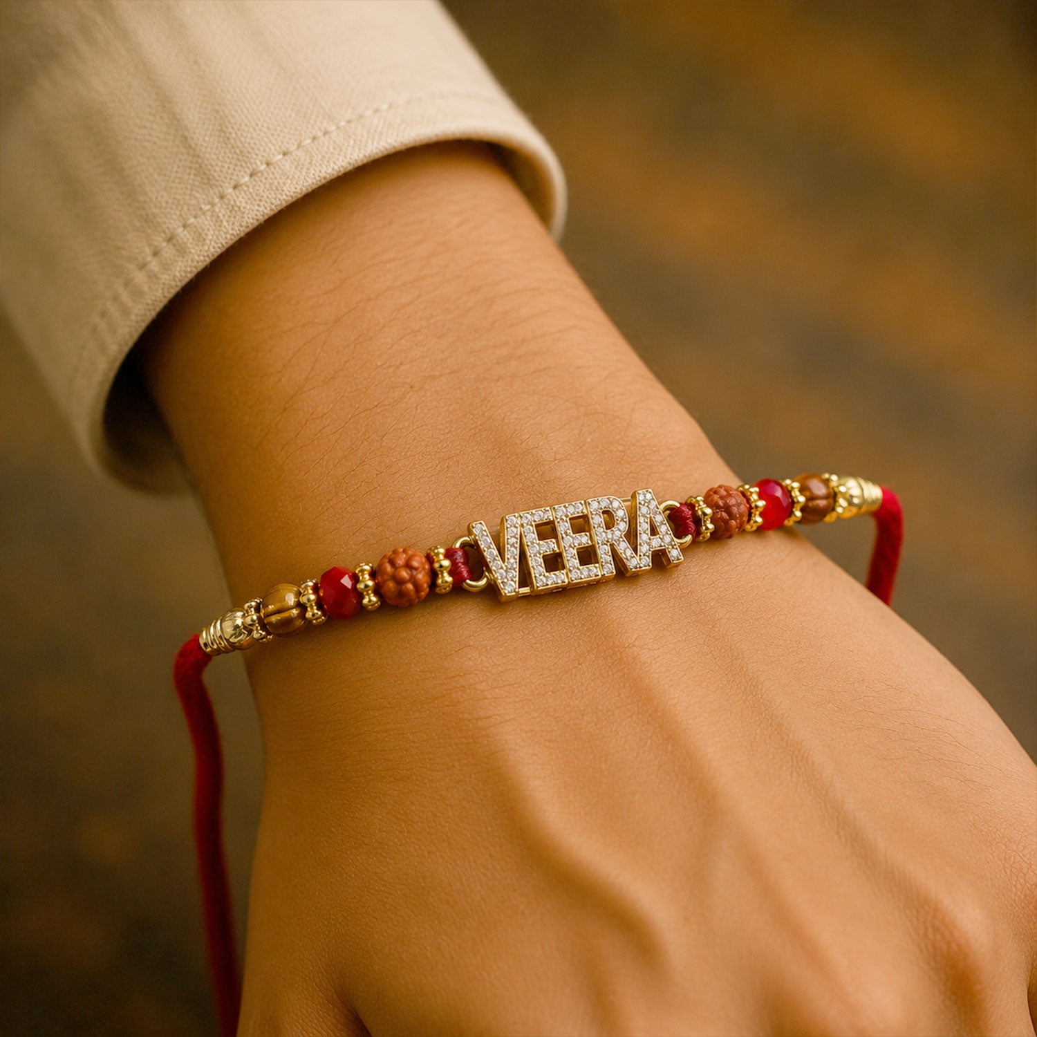 Veera Name Golden Designer Rakhi with Red Stones, Pearl Accents and Festive Beads
