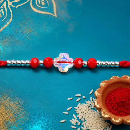 Red Thread Rakhi with Red Beads and an Iridescent Quatrefoil Crystal