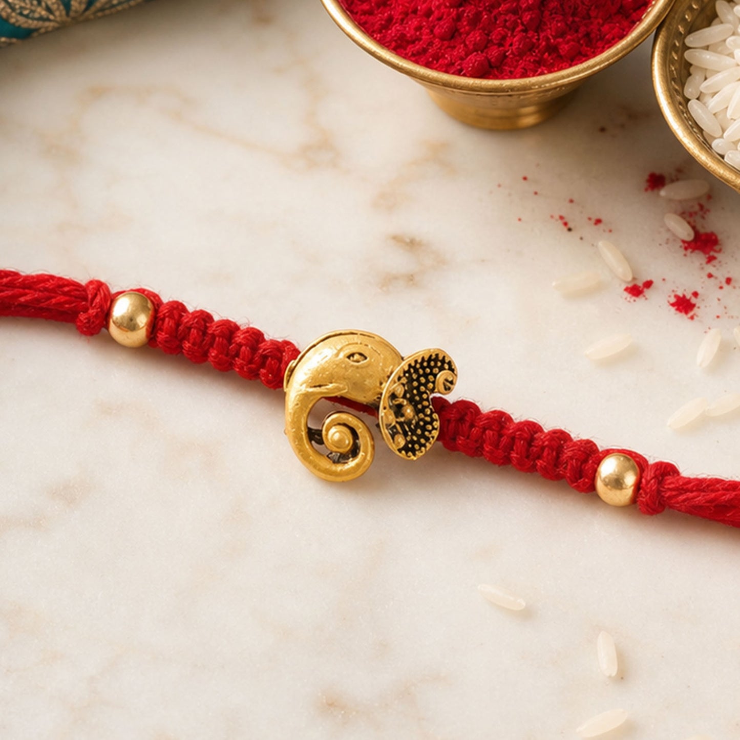 Red Thread Rakhi with Antique Gold Elephant-Shaped Charm Pendant