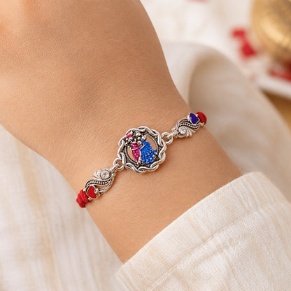 Silver-Toned Radha Krishna Rakhi with Colorful Enamel, Crystal Accents & Designer Red Thread