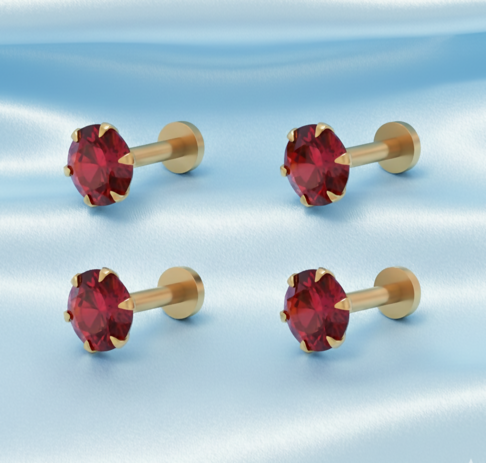 Close-up of gold plated ruby nose stud featuring 4-prong setting and 2mm round ruby stone