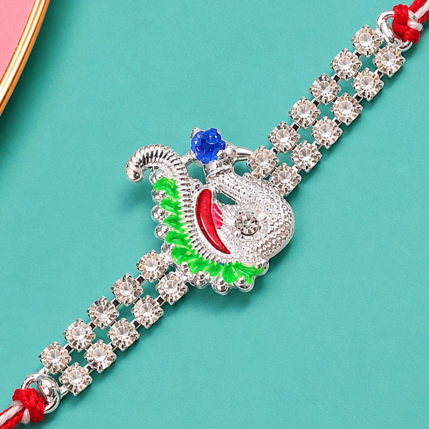 Festive Rakhi with Peacock Charm, pink accents and display look for Gift Styling