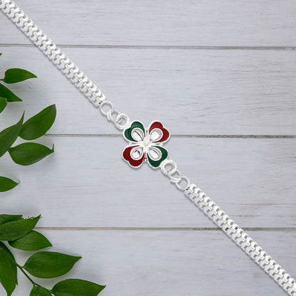 Close up of tricolor enamel rakhi showcasing intricate floral details.