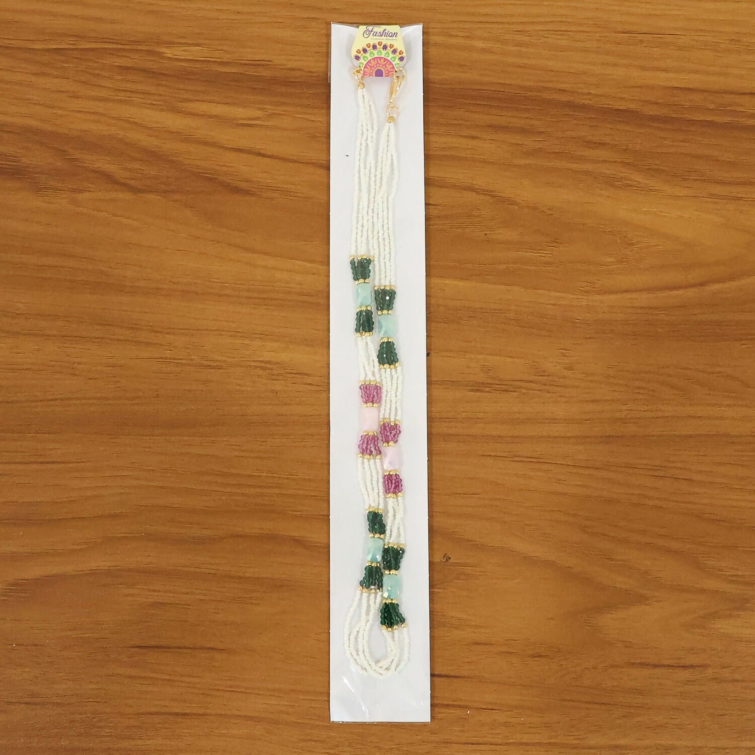 Multicolor handmade mala necklace displayed on stand