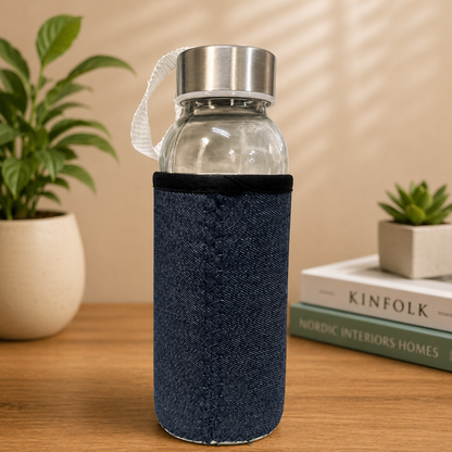 Glass water bottle with gray protective sleeve and strap side view