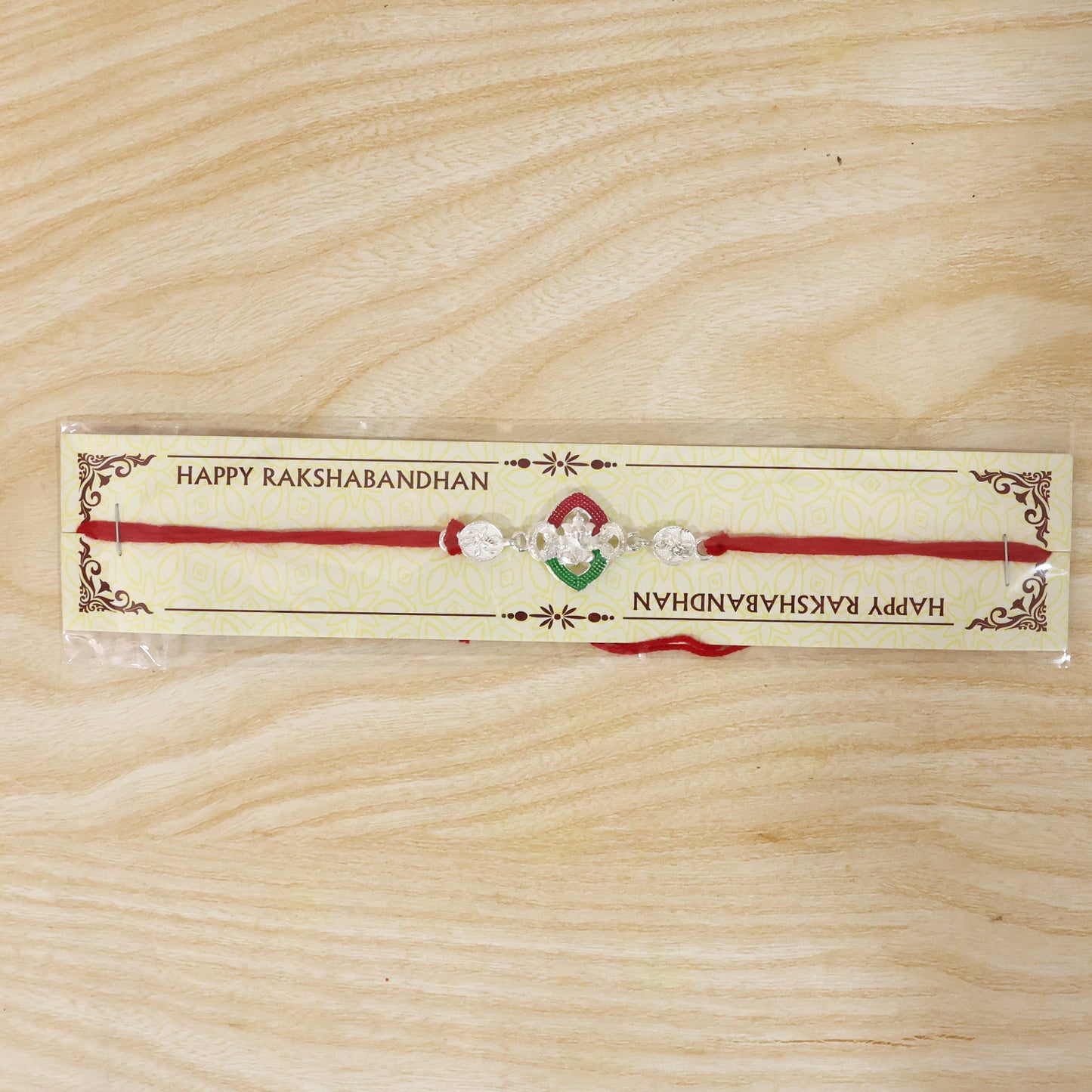 Silver Green Floral Rakhi with Red Thread and White Side Charms