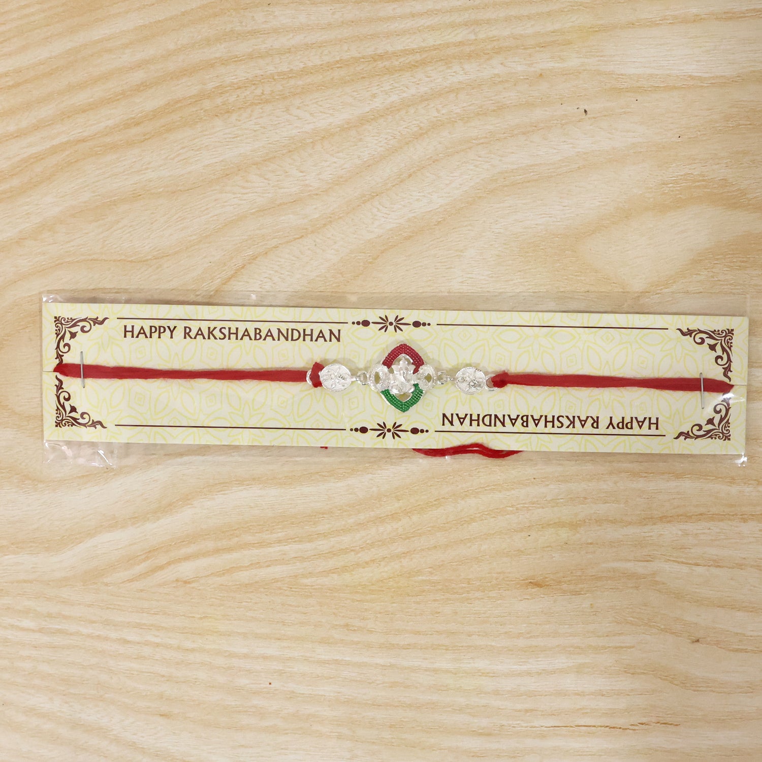 Silver Green Floral Rakhi with Red Thread and White Side Charms
