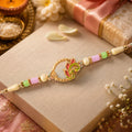 Enamel Peacock Pendant Rakhi with Green and Orange Beads