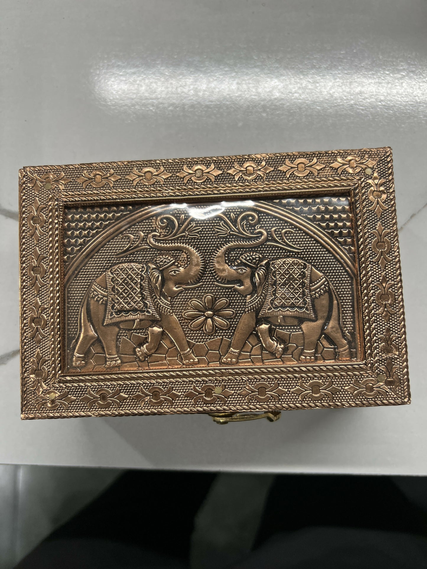 Close-up detail of elephant embossed copper jewelry box