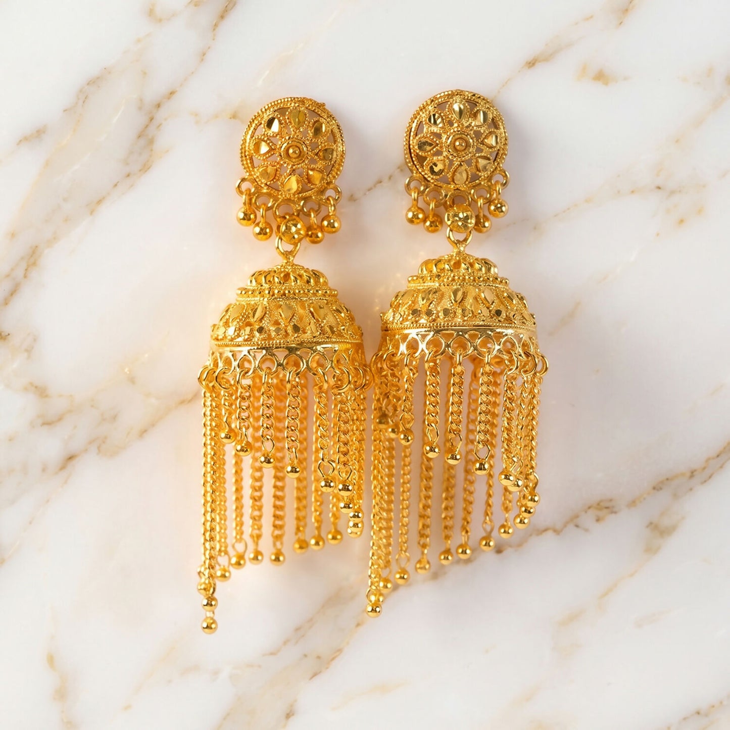 Detailed view of round top on golden jhumka earrings
