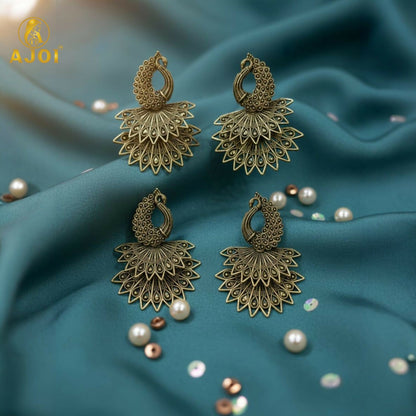 Close-up of intricate antique gold peacock earrings design