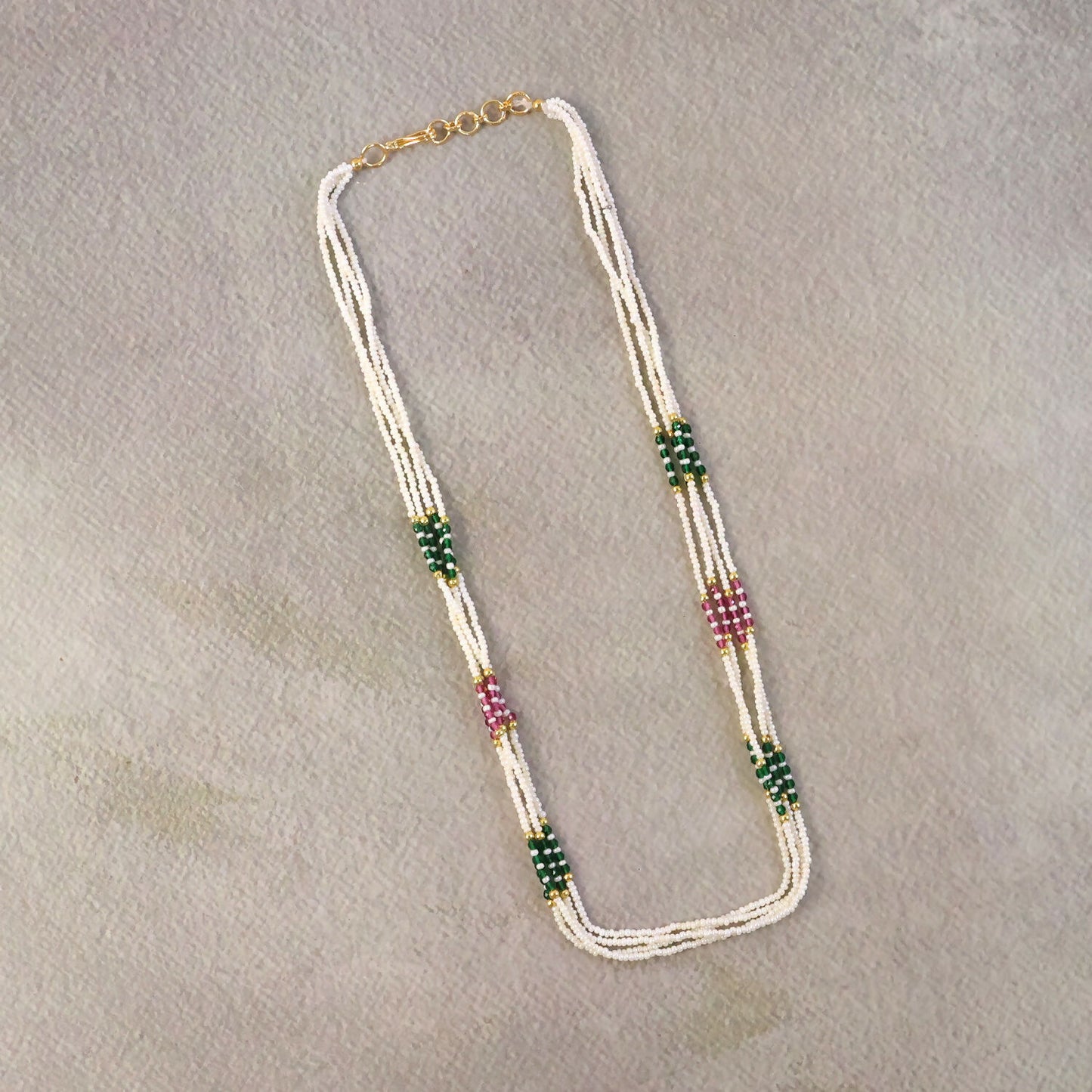 Gold-toned detailing on pearl mala necklace with vibrant beads