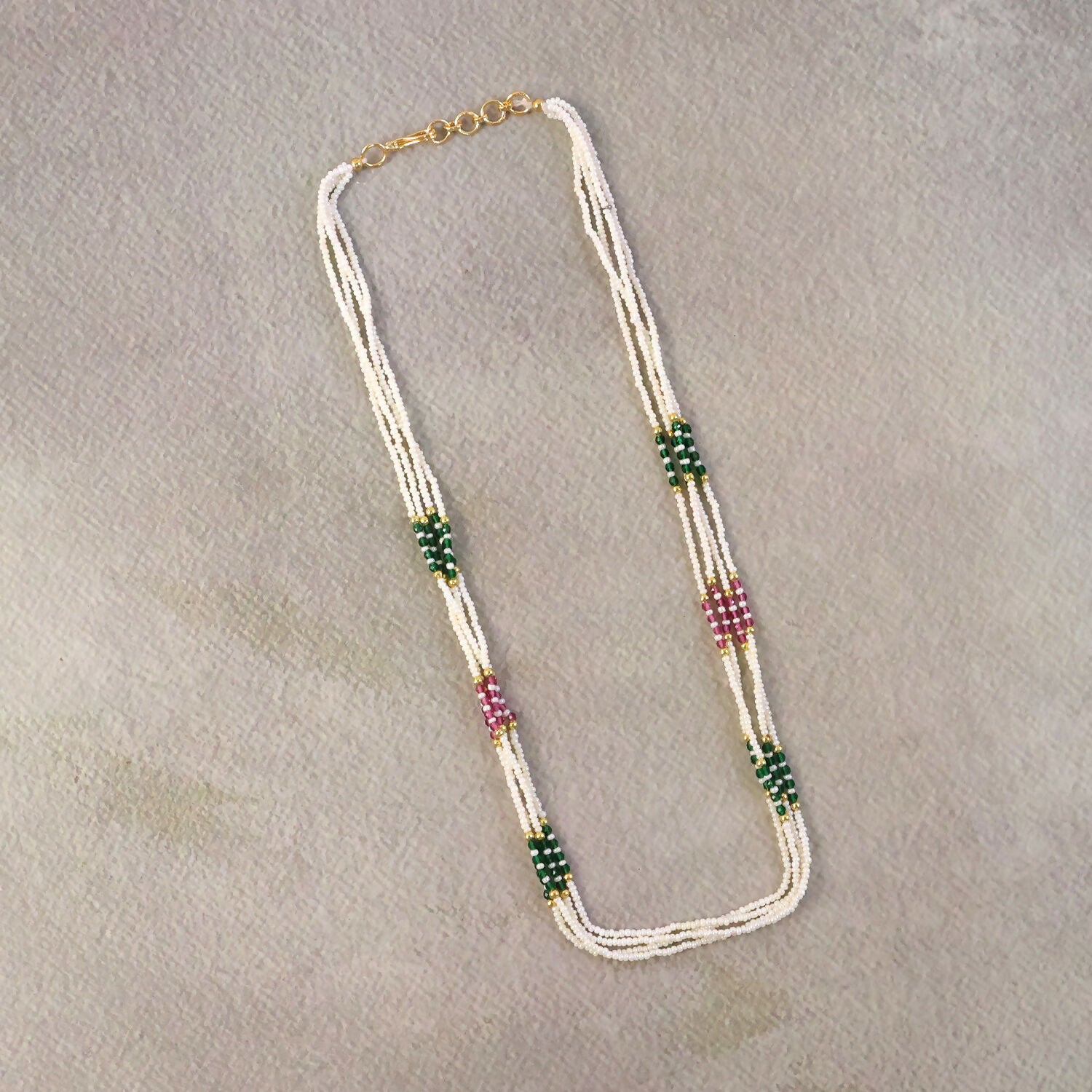 Gold-toned detailing on pearl mala necklace with vibrant beads