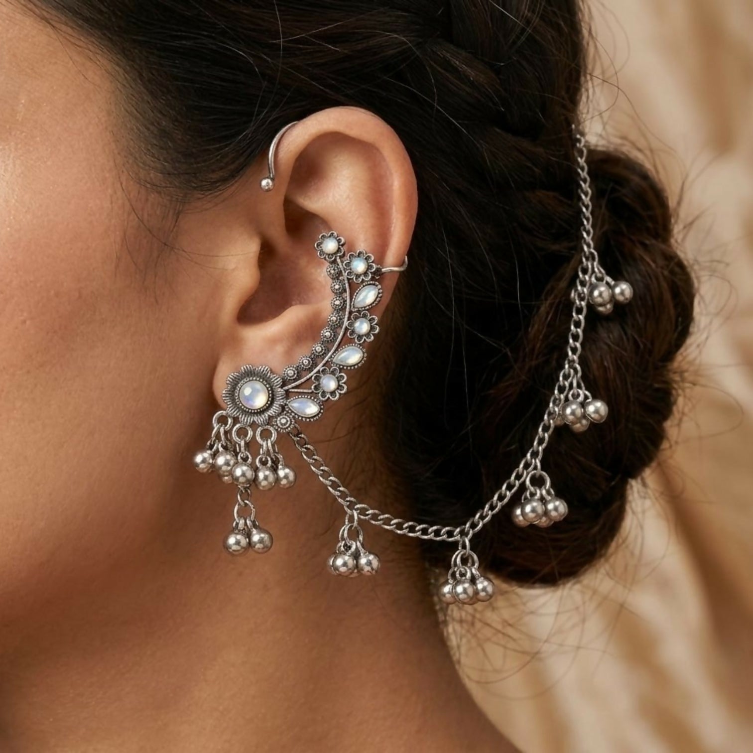 Side view of vintage silver floral ear cuff jhumka earrings with ghungroo drops