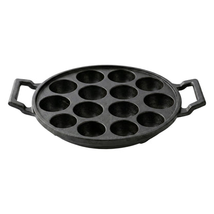 Cast iron pan with 12 cavities ready for cooking traditional snacks