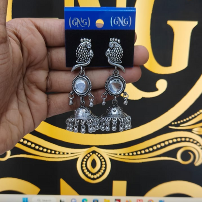 Pair of silver traditional peacock jhumka earrings with intricate craftsmanship and ghungroo jingles