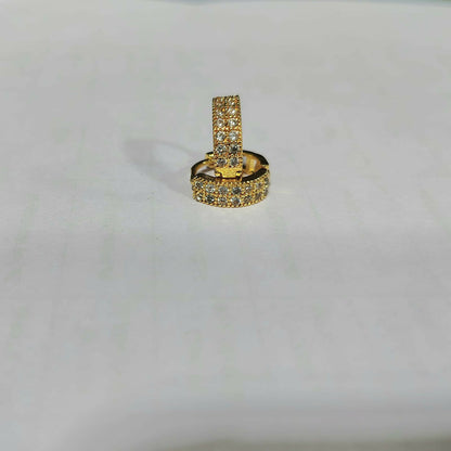 Single gold plated huggie hoop earring featuring multicolored CZ stones