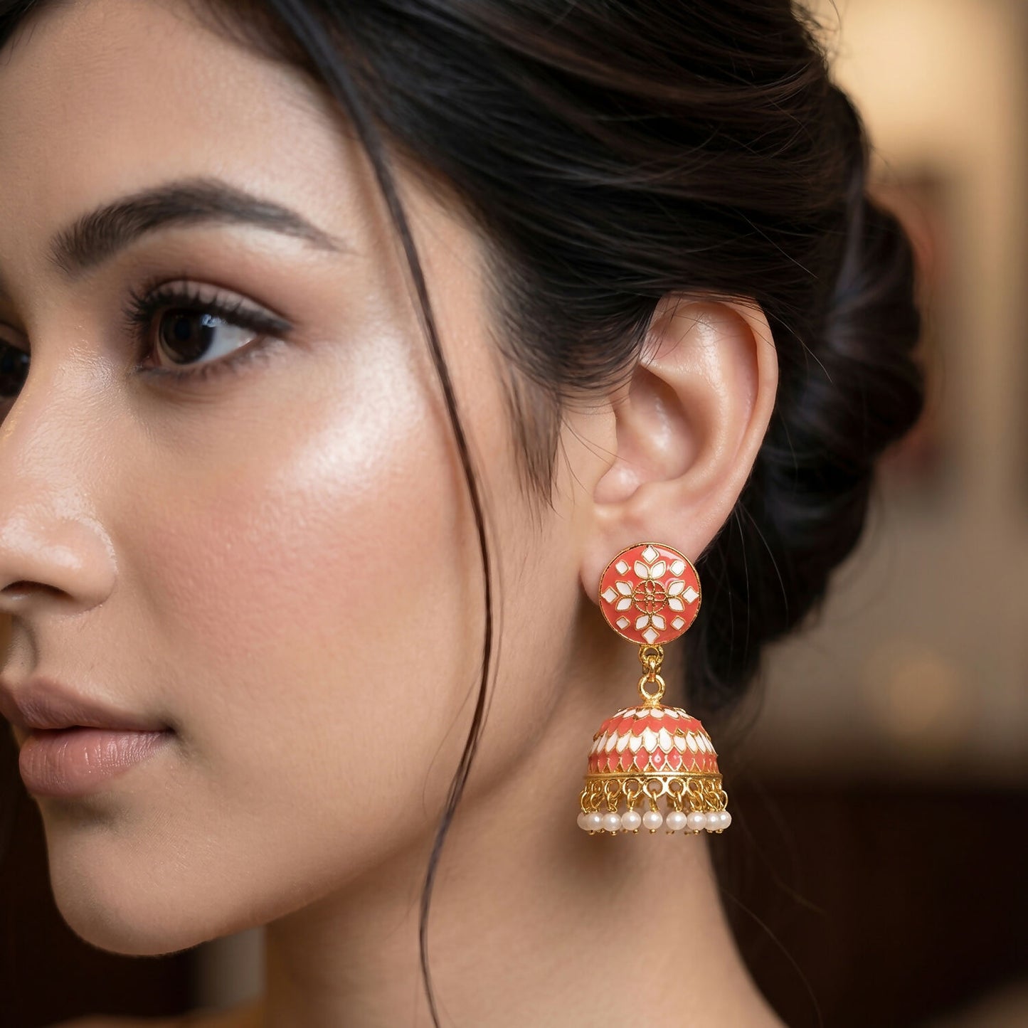 Close-up of peach patterned dome on jhumka earrings
