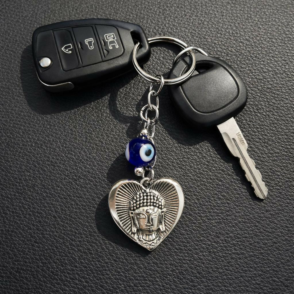 Buddha evil eye heart keychain attached to a set of keys
