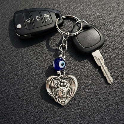 Buddha evil eye heart keychain attached to a set of keys