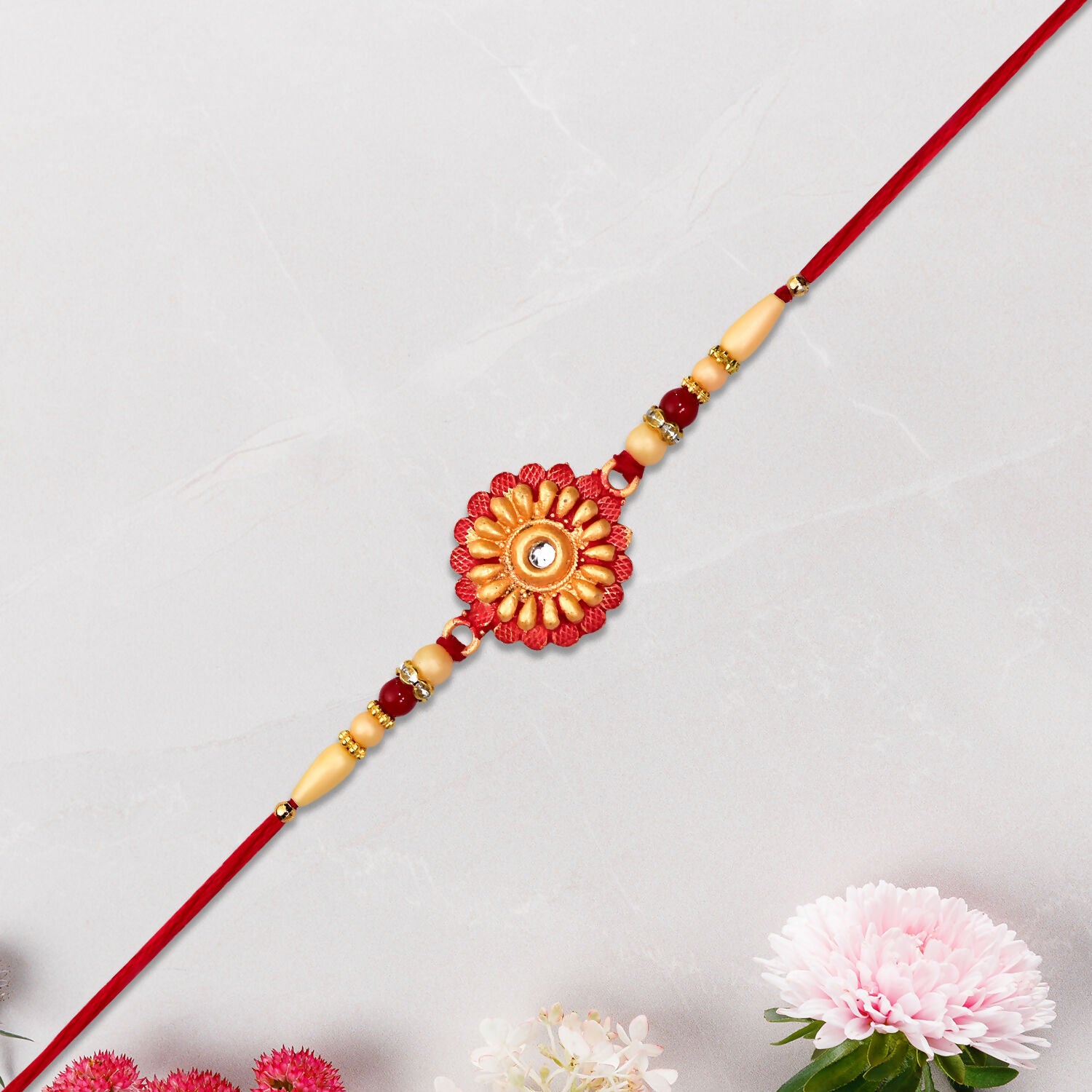 Detailed view of rakhi showing floral beads and stone