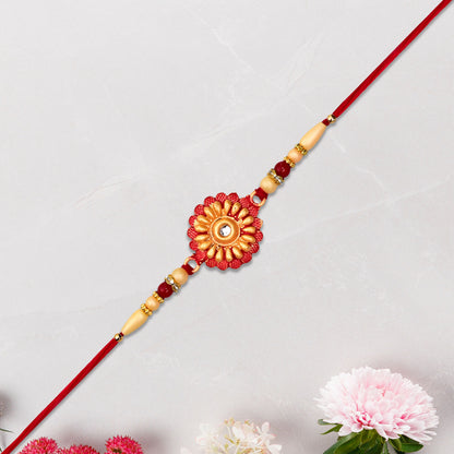 Detailed view of rakhi showing floral beads and stone