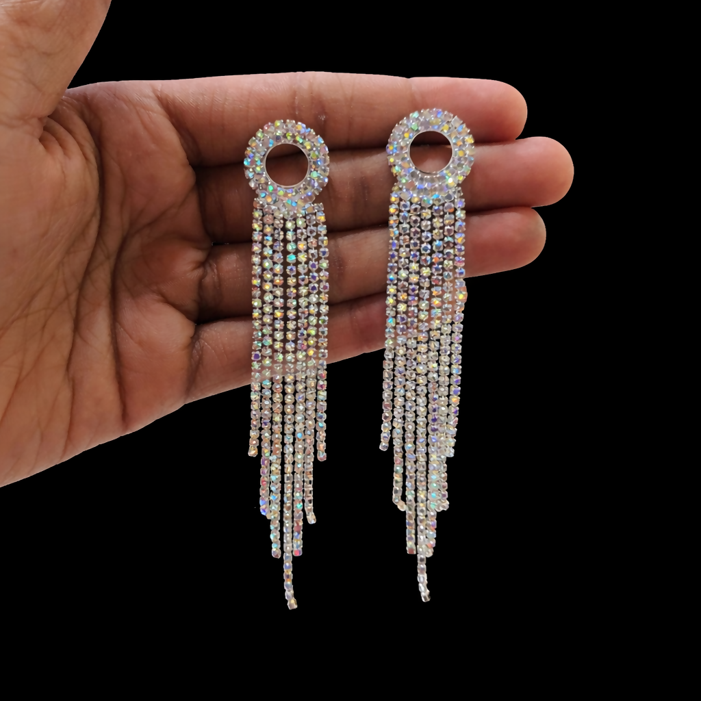 Close-up of long earrings featuring shimmering crystal strands for luxurious effect