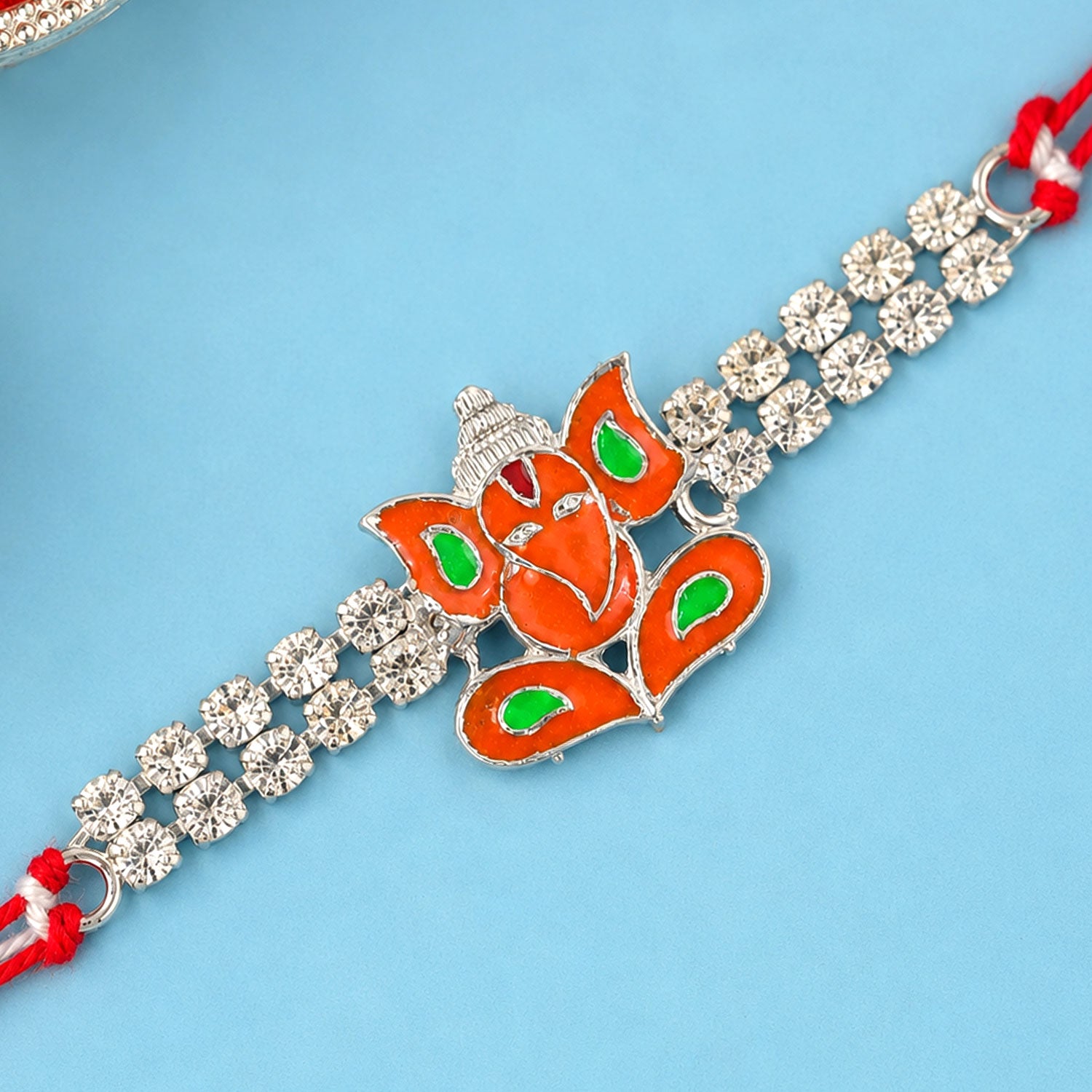 Silver-Toned Lord Ganesha Rakhi with Orange-Green Enamel, Double Crystal Chain & Red Thread