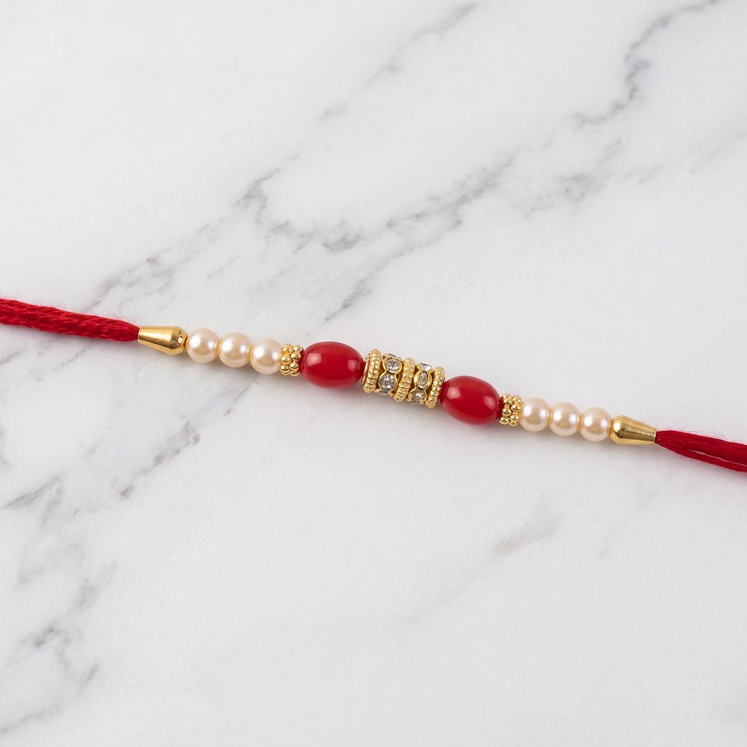 Red Moti Rakhi with Pearl Line and Antique Gold Spacer Beads