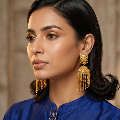 Close-up of golden dome style jhumka earrings